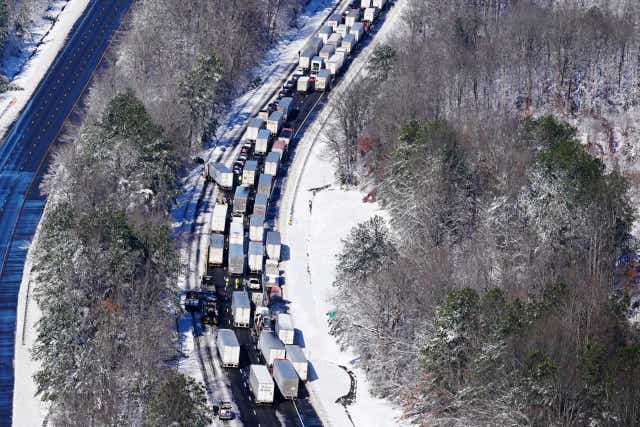 <p>Drivers wait for the traffic to be cleared as cars and trucks are stranded on sections of Interstate 95 in Carmel Church, Virginia on 4 January 2022</p>