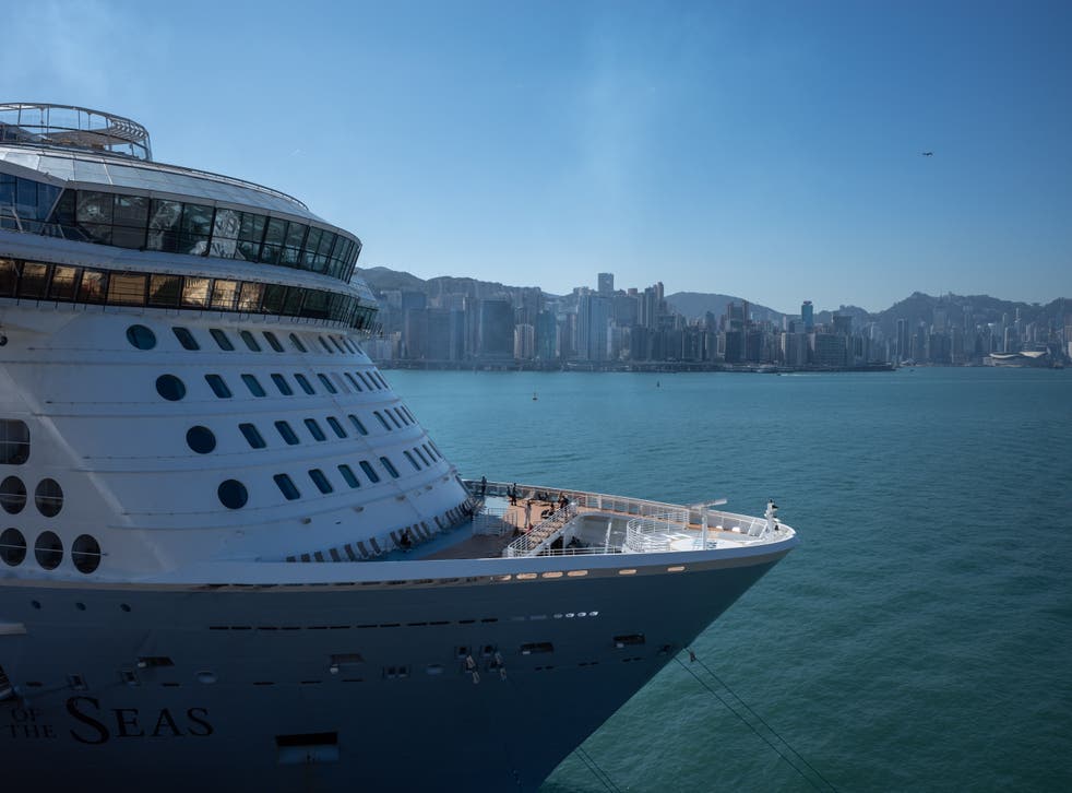 <p>Passengers stand on the deck of the Royal Caribbean vessel ‘Spectrum of the Seas’ at Kai Tak Cruise Terminal in Hong Kong</p>