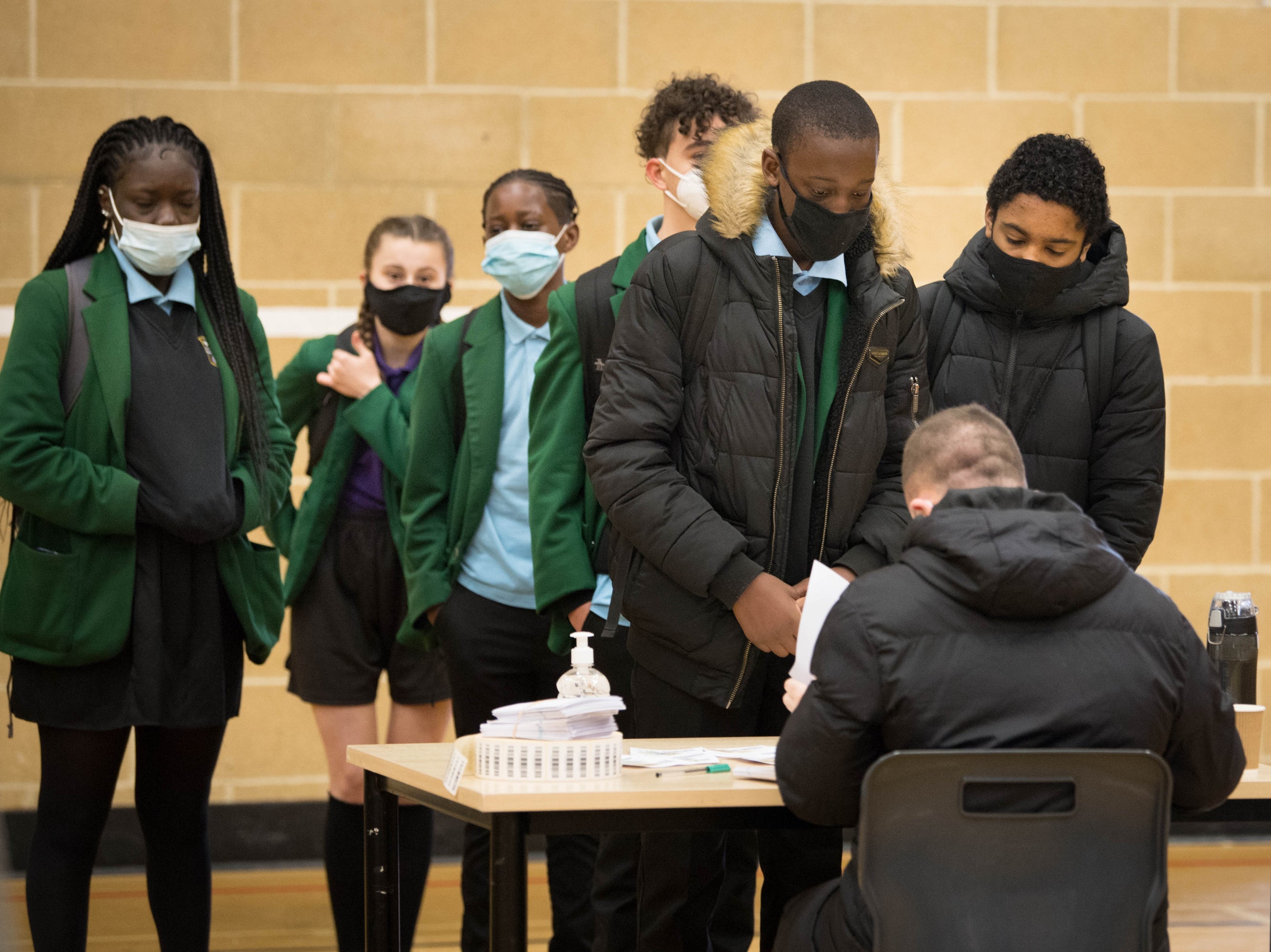 <p>Pupils at Sydney Russell School in Dagenham, east London, queue up to be tested</p>