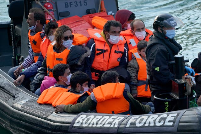 People are brought in to Dover, Kent, by Border Force officers (Gareth Fuller/PA)