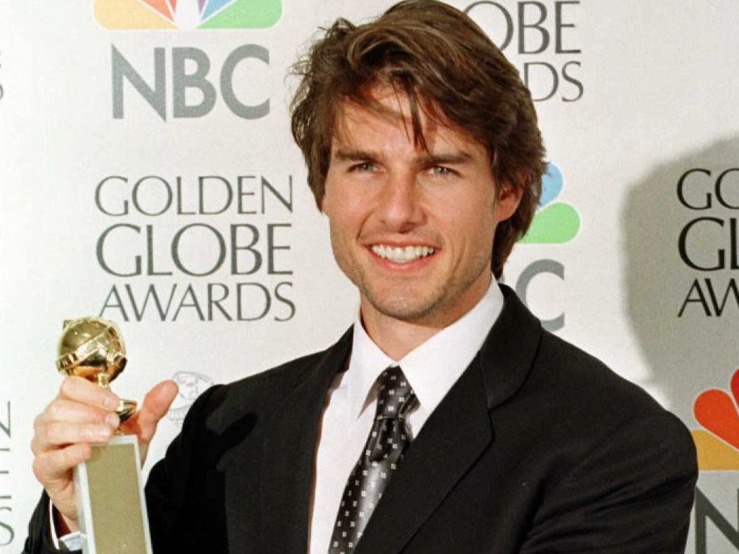 Tom Cruise holding a Golden Globe award