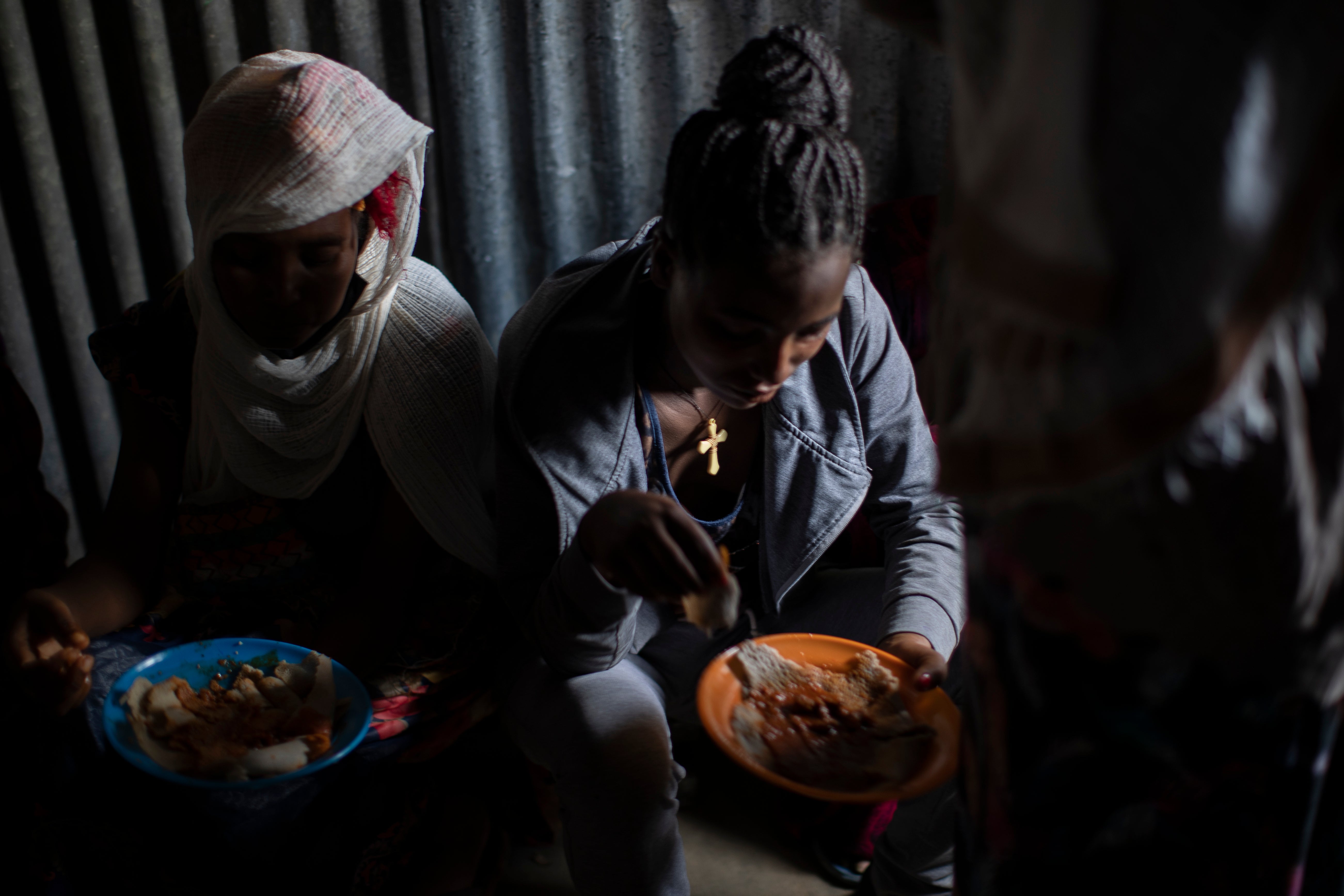 File photo: Displaced Tigrayan women eat in the Tigray region of northern Ethiopia, on 9 May 2021