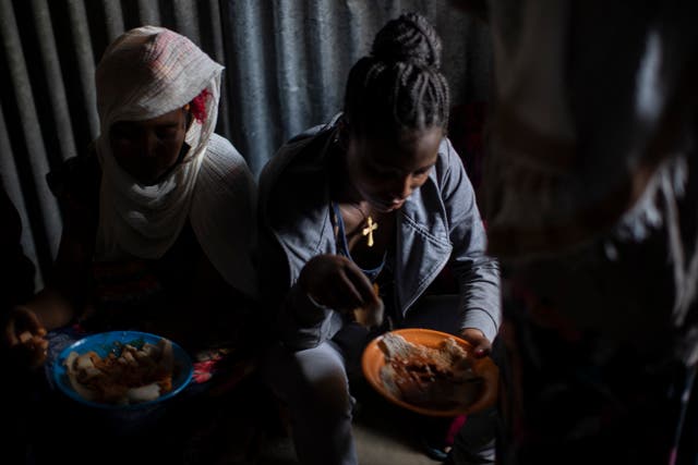 <p>File photo: Displaced Tigrayan women eat in the Tigray region of northern Ethiopia, on 9 May 2021</p>
