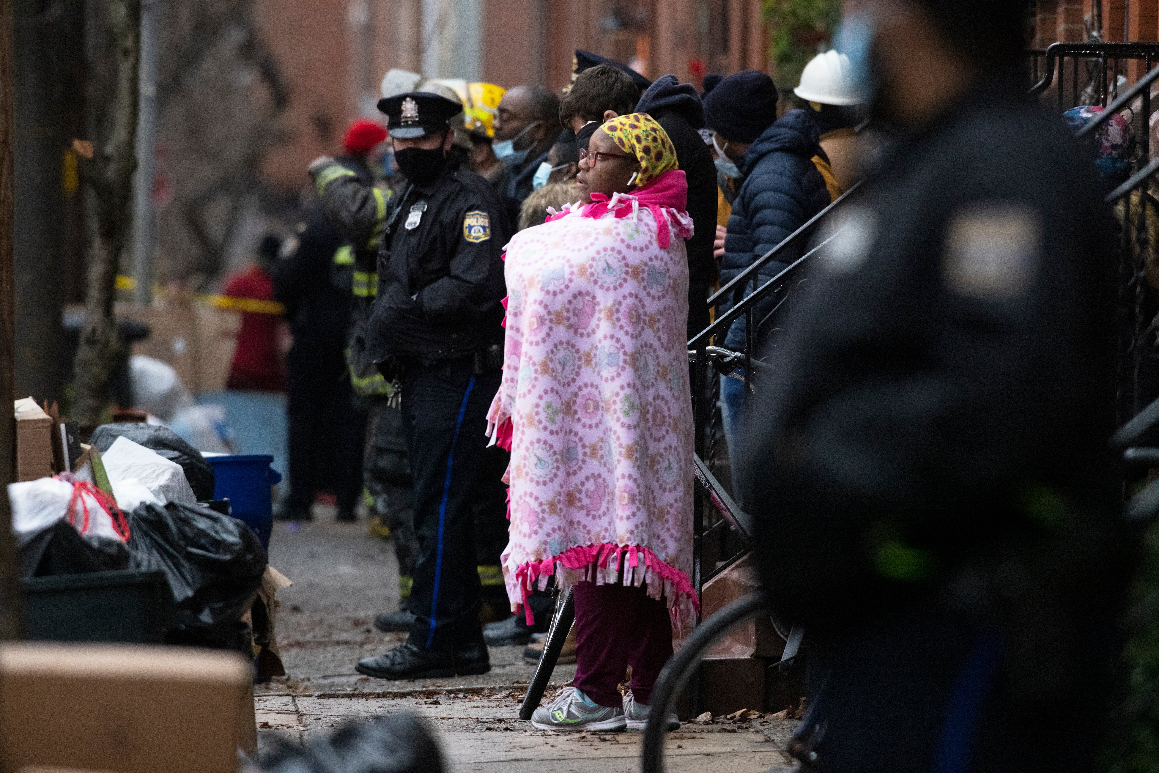 Bystanders watch as the fire department works at the scene