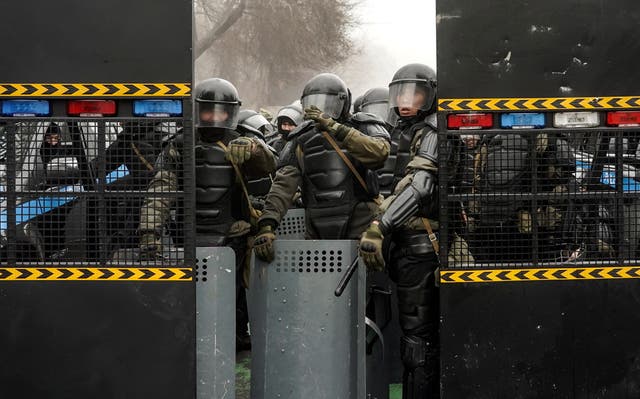 <p>Riot police block a street after the Kazakh president declared a state of emergency </p>