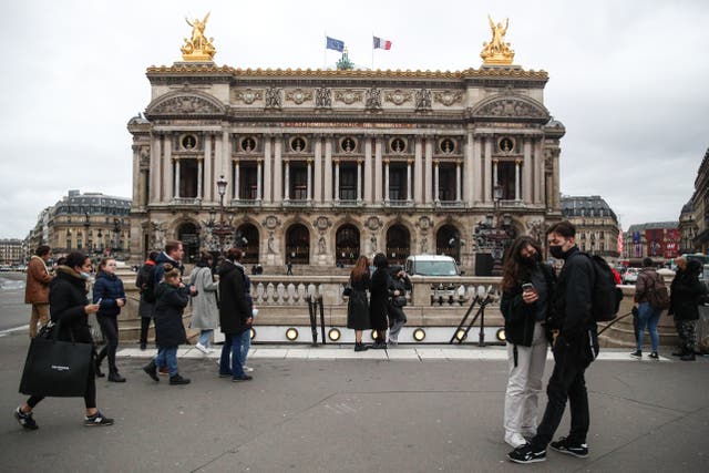 <p>File photo: Pedestrians wearing face masks walk near the Palais Garnier opera house in Paris, France, 4 January 2022</p>