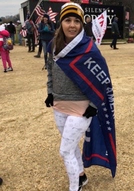 Kelsey Leigh Ann Wilson is pictured in a Trump flag which she later wore when she entered the Capitol