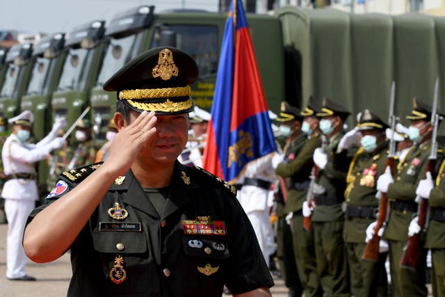 <p>Hun Manet salutes as he leaves a military ceremony in Phnom Penh, June 2020</p>