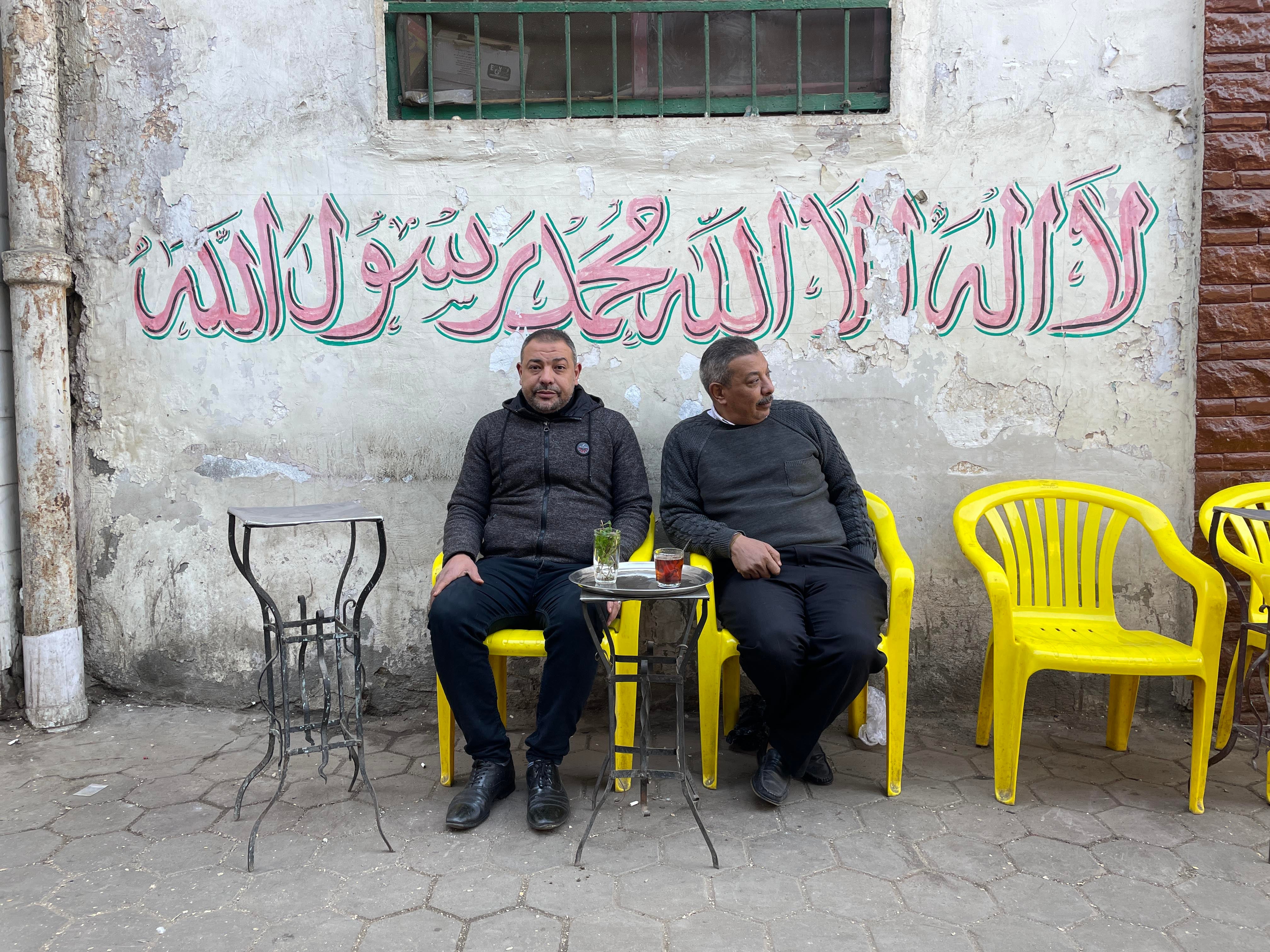 Yasser el-Fahl, left, and brother Mohamed sit outside their ahwa, or cafe. Yasser was jailed and fined for using his personal shisha in the cafe