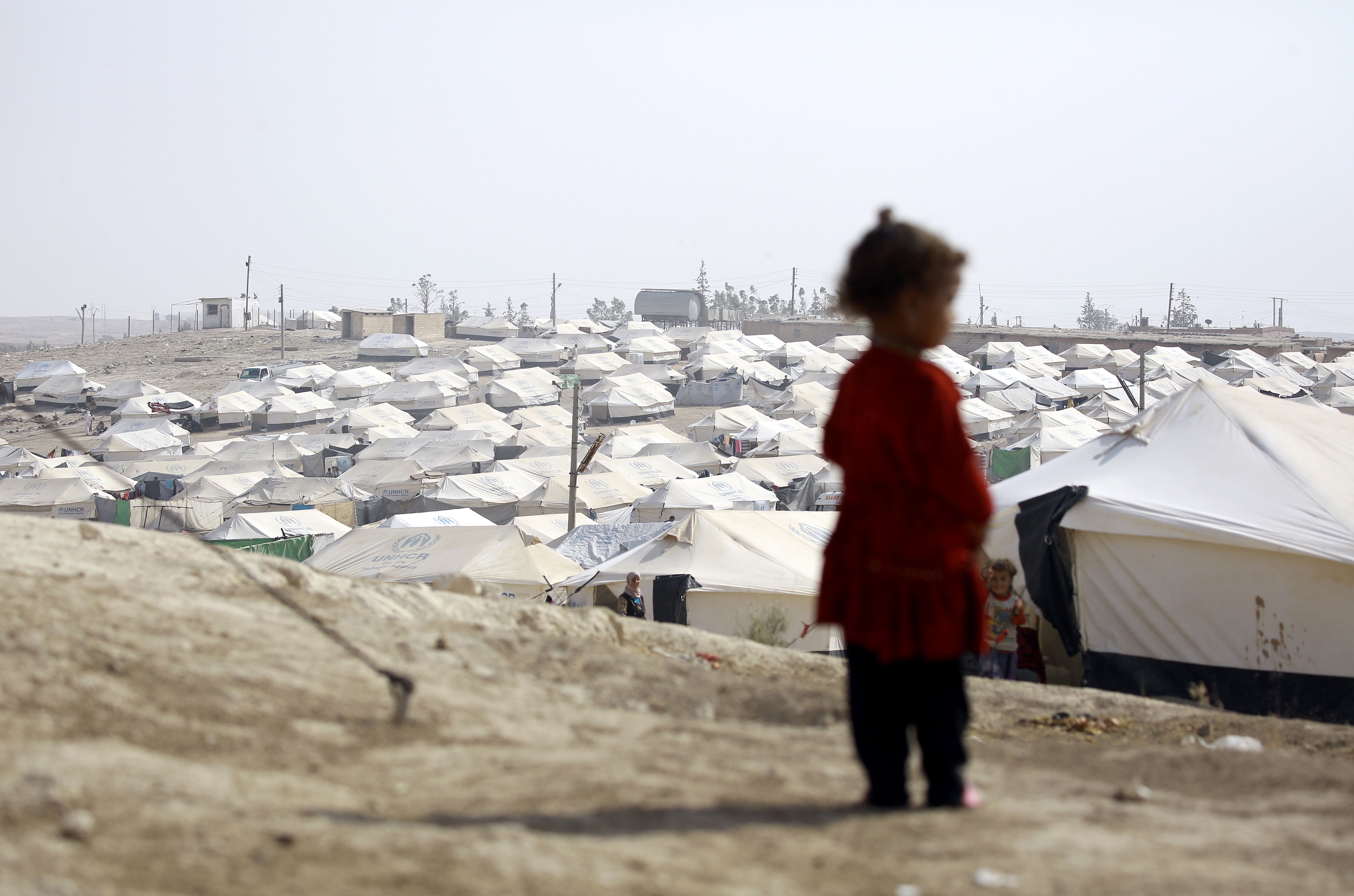 A child looks over the Al-Hol camp in northeast Syria