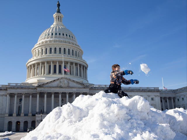 <p>Kids play on top of a large pile of snow that was piled up after the East Front of the US Capitol was cleared following a snowstorm, in Washington, DC, USA, 04 January 2022</p>