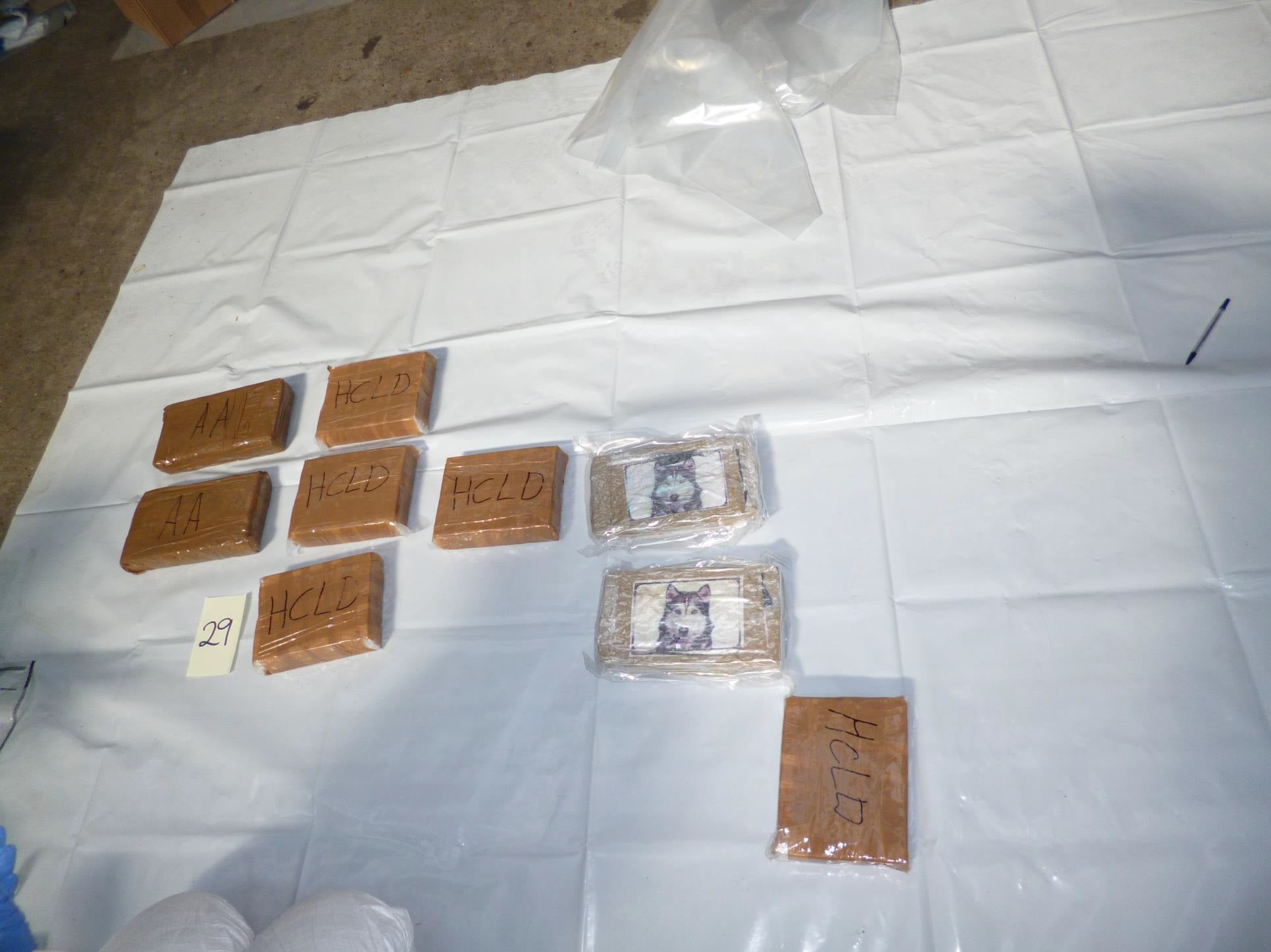 (PA/ NCA) Law enforcement found 183kg of cocaine and heroin within packages inside the van