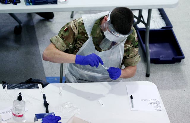 A soldier carrying out Covid testing (Peter Byrne/PA)
