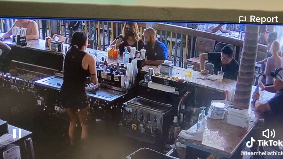 A Florida bartender uploaded security footage from her workplace on her TikTok, showing a woman throwing a drink at her after she got angry that a bug flew in it