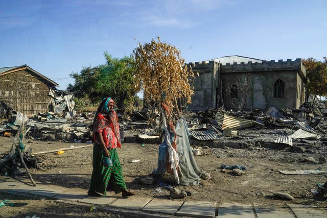 <p>A woman walks past the mosque at Darsageta that had been heavily damaged by the Tigray People’s Liberation Front, a week ago.  </p>