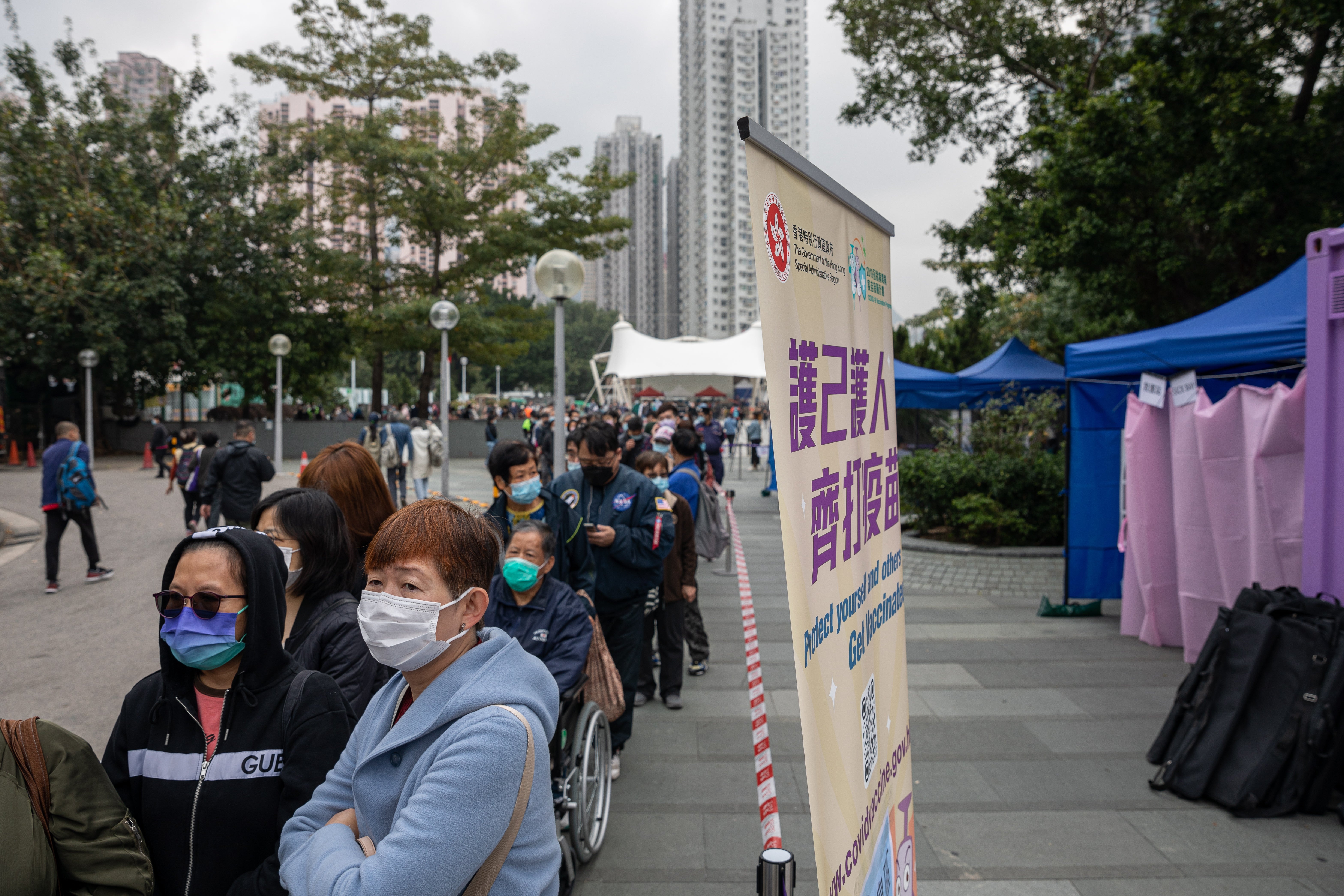File: Residents line up to receive Covid vaccines at a mobile vaccination station in Hong Kong