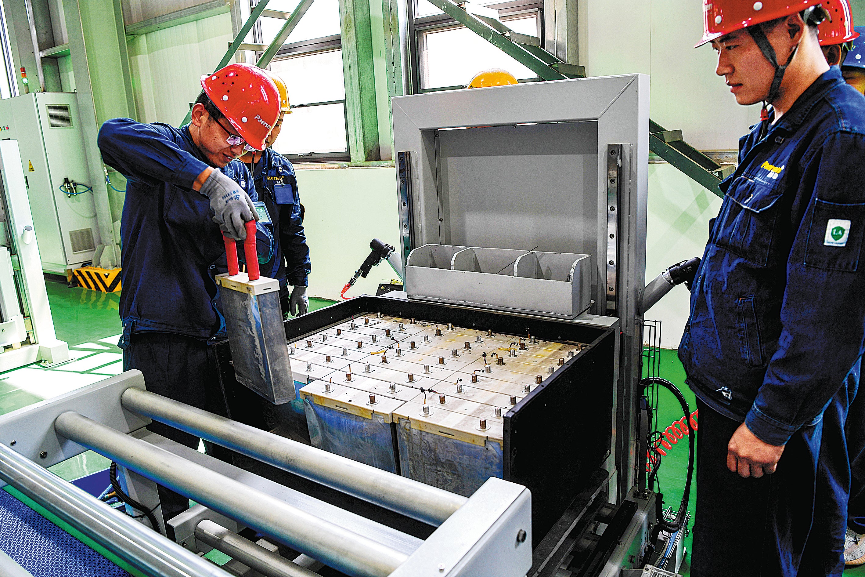 Employees arrange spent batteries at a battery recycling plant in Weinan, Shaanxi province, in August, 2021