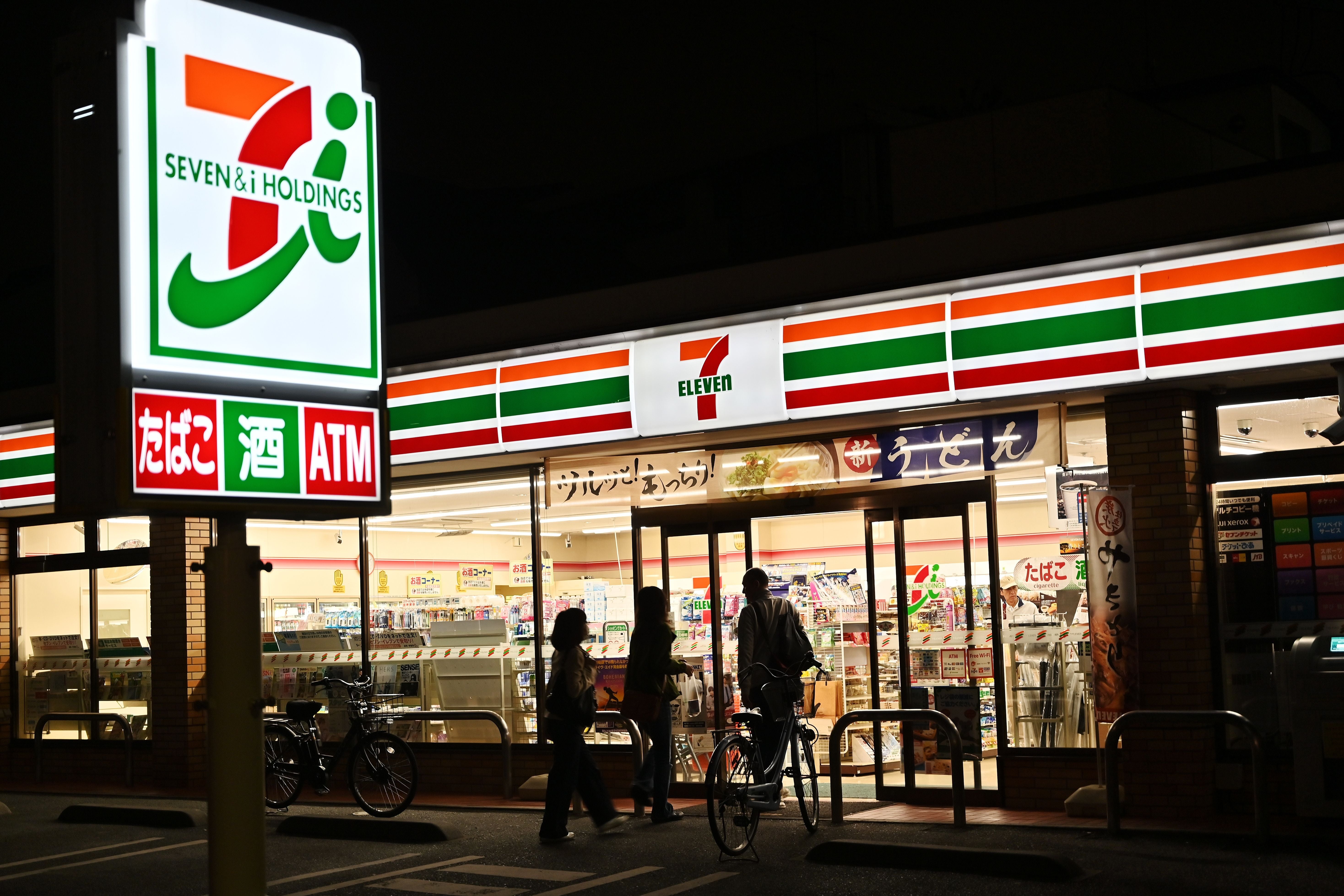 File: A 7-Eleven convenience store at night in Tokyo