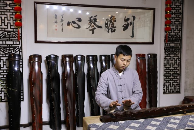 <p>Xu Yachong plays the guqin in Xuchang village of Lankao county, Henan province</p>