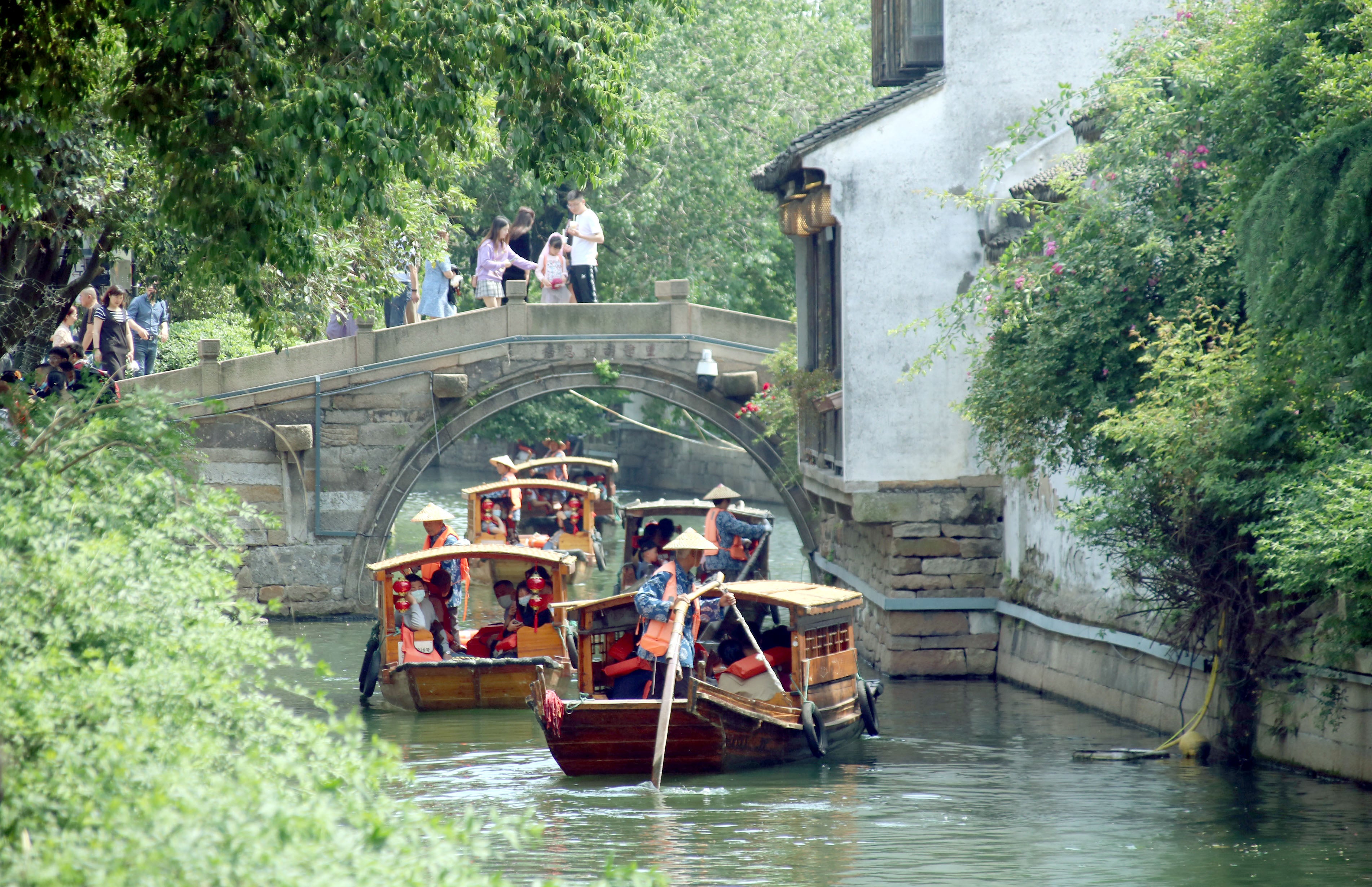 Tourists enjoy cruising on a canal near Pingjiang Road, an ancient area centred on a one-mile-long lane that boasts a long history in Suzhou, Jiangsu province