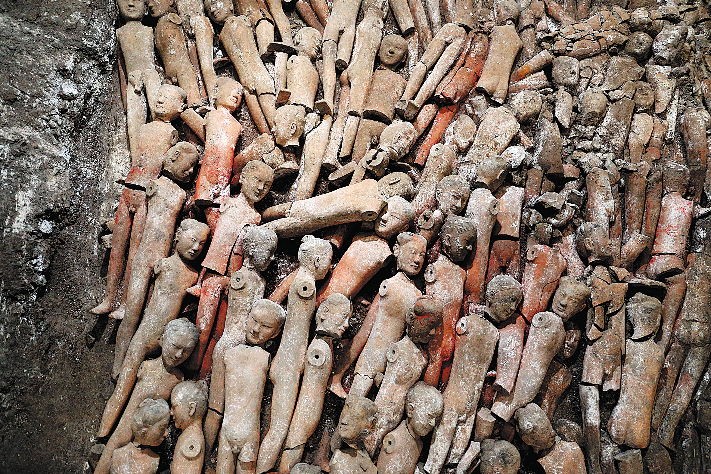 Pottery figurines lie on the floor of the tomb