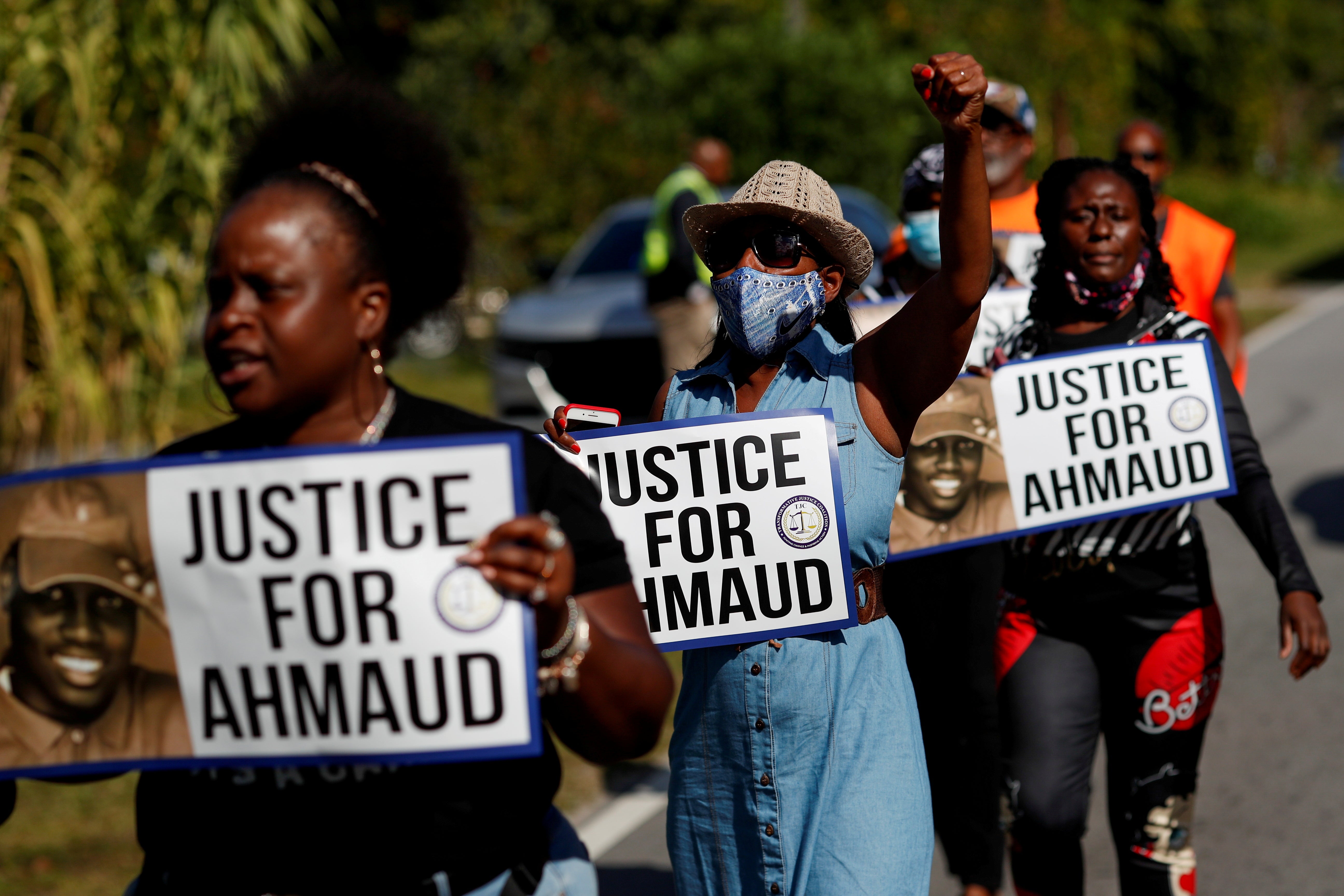 Protesters holding signs calling for Justice for Ahmaud Arbery