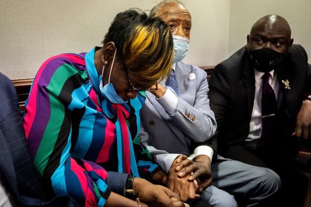 <p>Ahmaud Arbery’s mother, Wanda Cooper-Jones, is comforted by Rev. Al Sharpton after the jury convicted Travis McMichael </p>