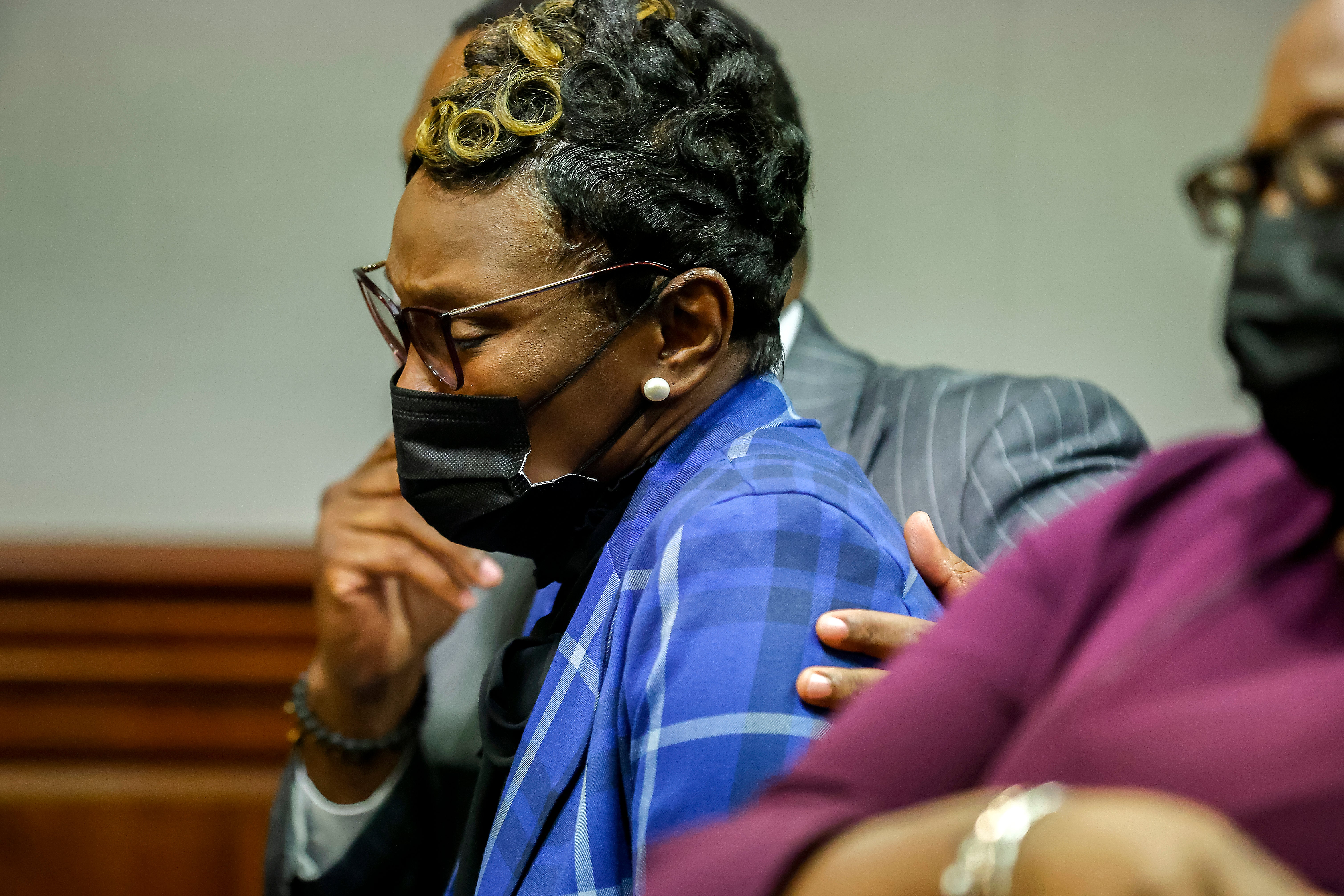 Ahmaud Arbery’s mother Wanda Cooper-Jones wipes a tear from her eyes while listening to her daughter’s impact statement in court on Friday