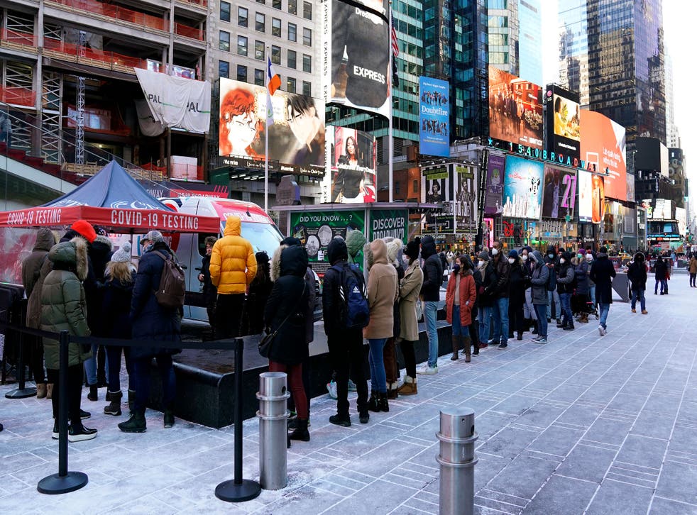 <p>People line up for Covid-19 testing in Times Square on 4 January 2022, in New York City. </p>