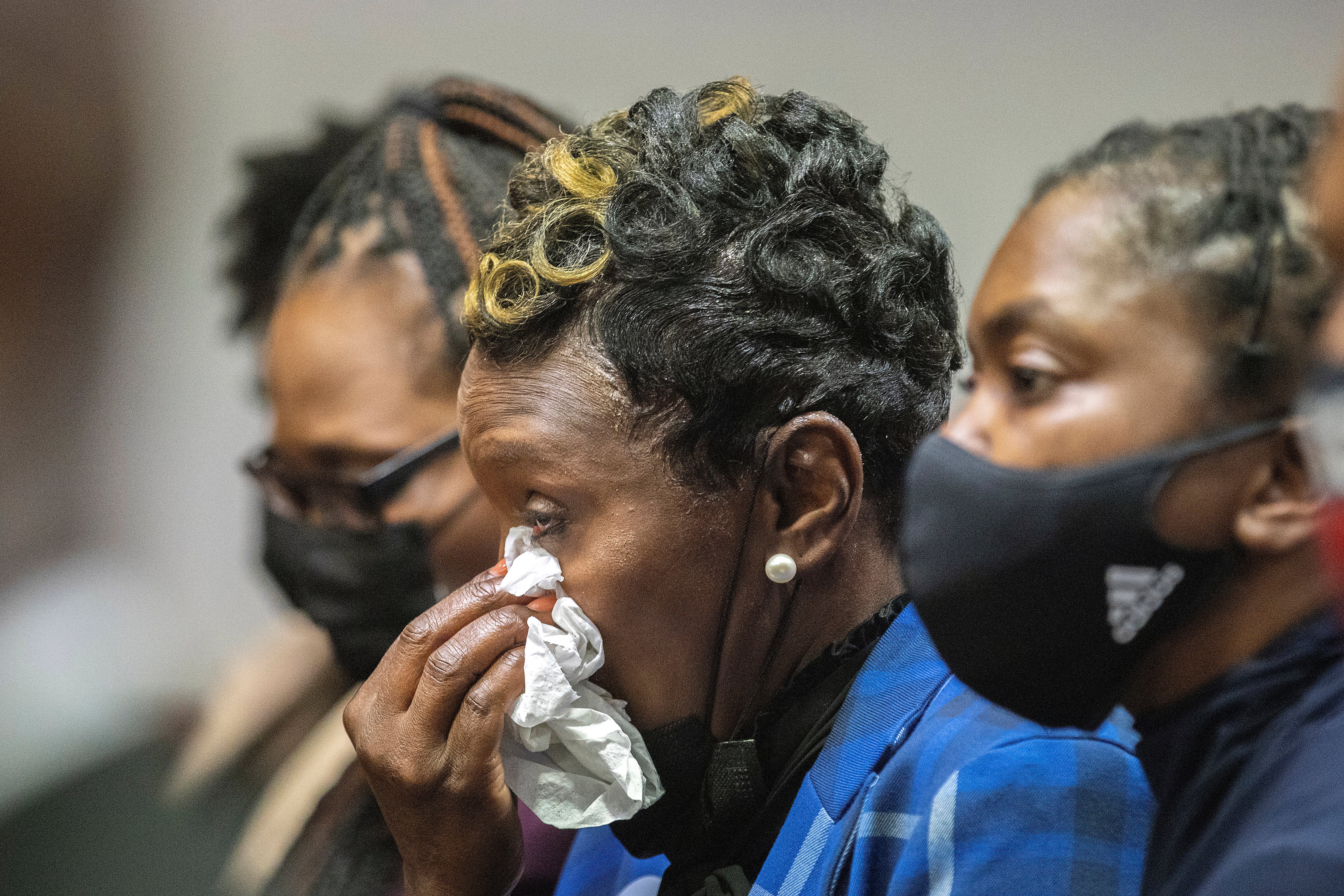 Ahmaud Arbery’s mother Wanda Cooper-Jones wipes away tears as the judge sentences her son’s killers