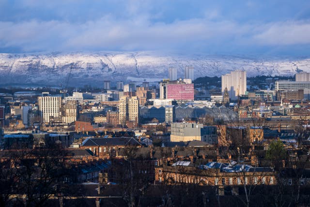 Glasgow is seen in front of the snow-covered Campsie Fells (Jane Barlow/PA)