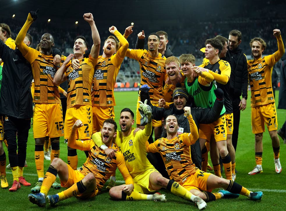 Cambridge players celebrate victory after the final whistle (Owen Humphreys/PA)