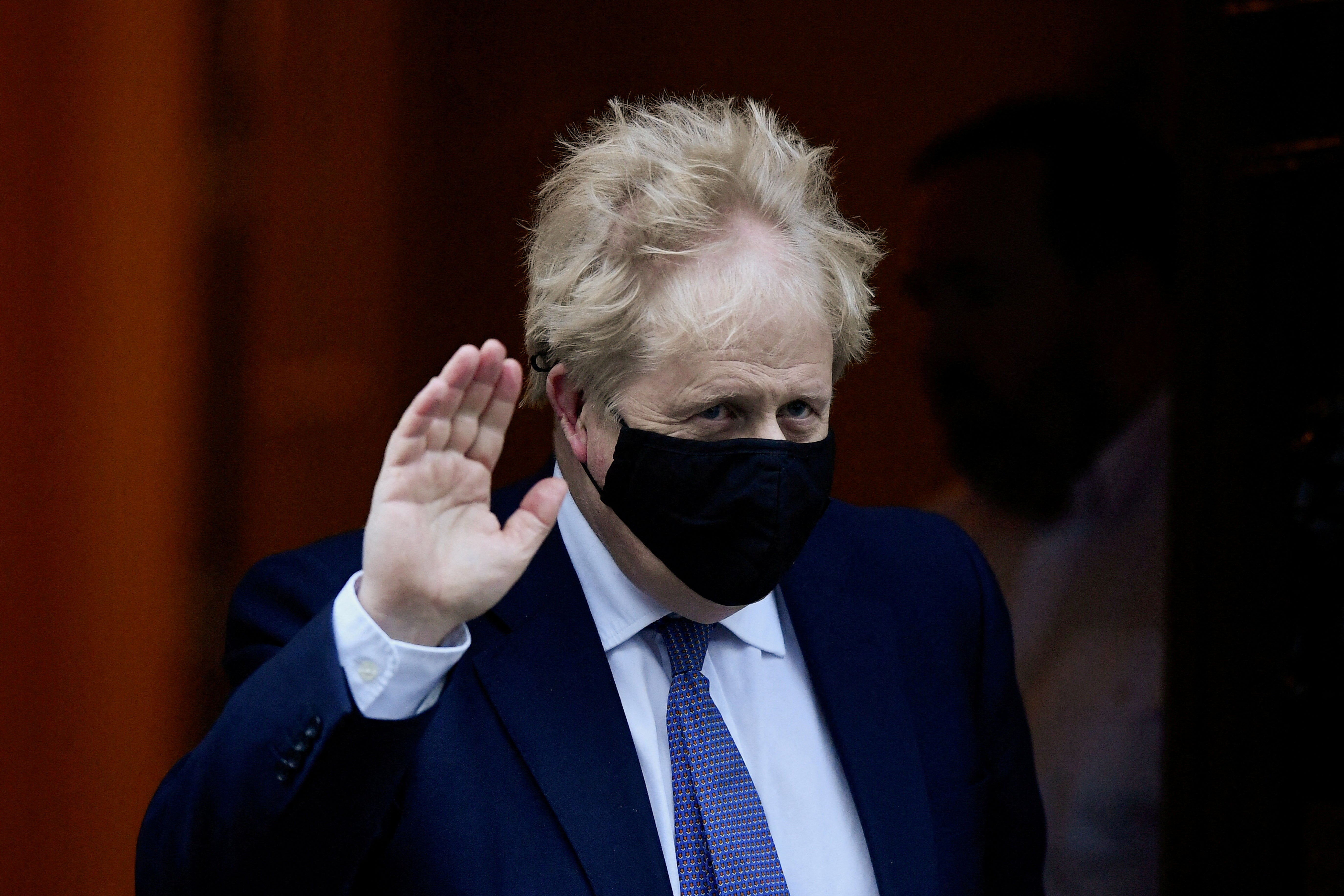Prime minister Boris Johnson gestures as he leaves Downing Street to attend Prime Minister's Questions in parliament