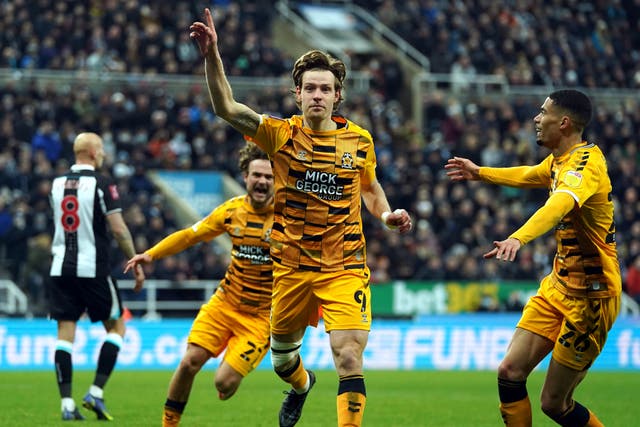 Cambridge striker Joe Ironside (centre) celebrates his winning goal at Newcastle (Owen Humphreys/PA)