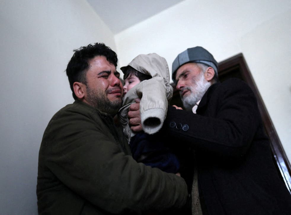 <p>Hamid Safi cries as he hands over Sohail to his grandfather Mohammad Qasem Razawi in Kabul</p>
