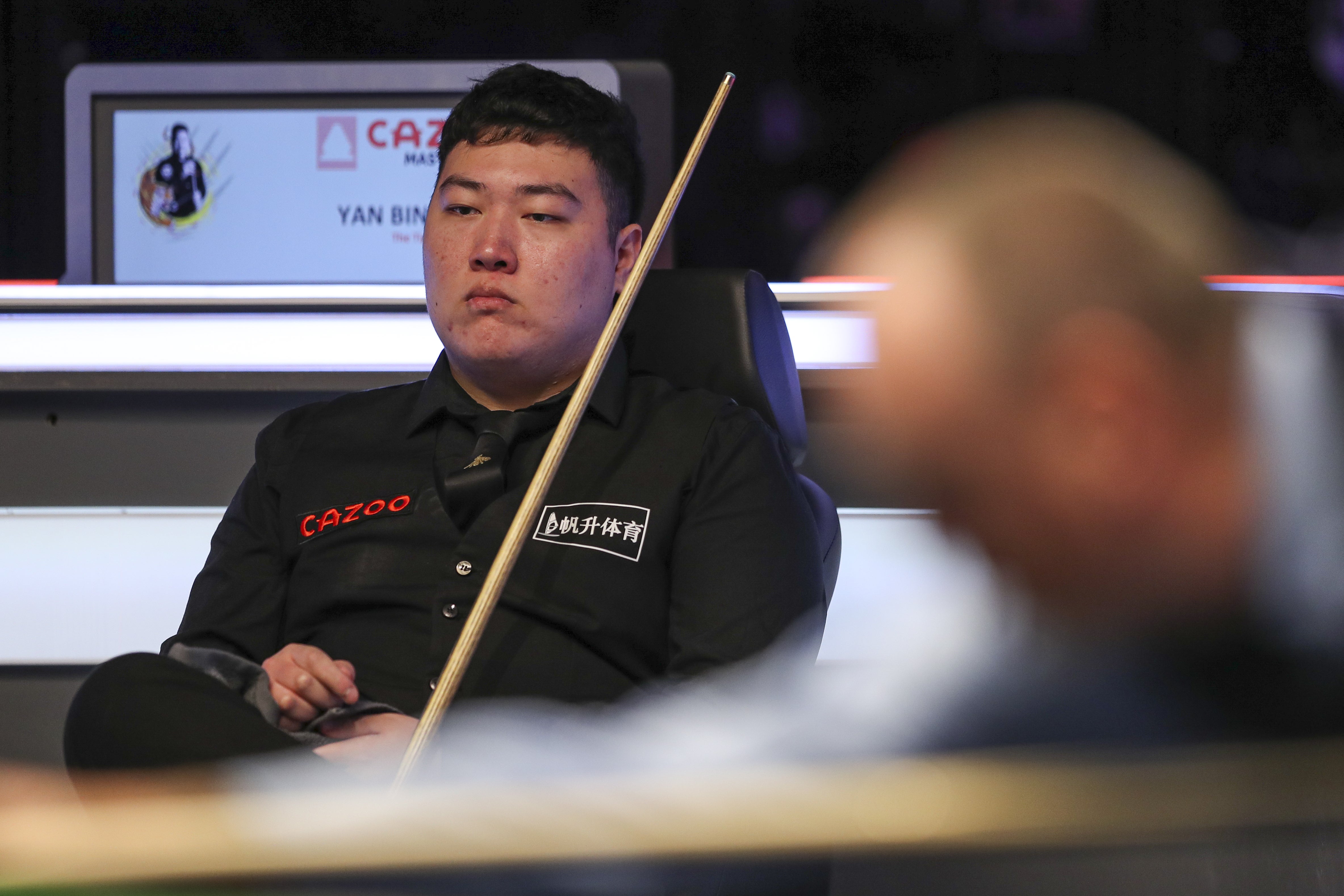Yan Bingtao watches while Mark Williams plays a shot during day one of the 2022 Cazoo Masters at Alexandra Palace (Kieran Cleeves/PA)