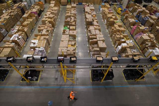 <p>Parcels are processed and prepared for dispatch at Amazon’s Fulfilment Centre at Kingston Park in Peterborough (Aaron Chown/PA)</p>