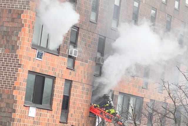 <p>Smoke rises from an apartment building in New York City’s Bronx where 19 people were killed in a deadly blaze on Sunday </p>