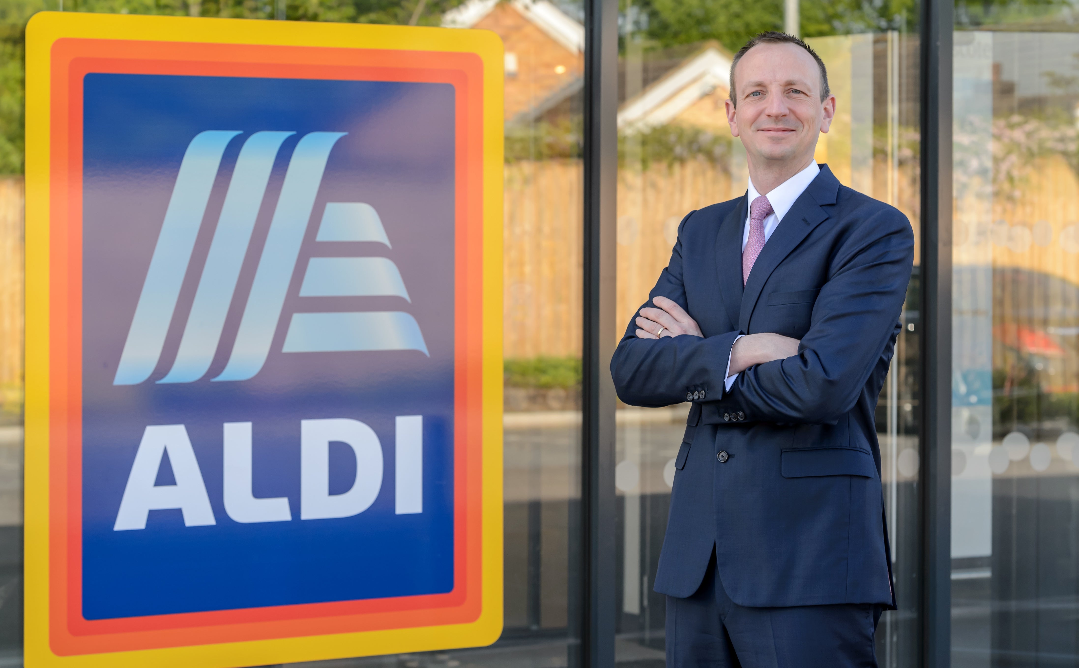 Aldi will commit to offering the lowest grocery prices amid rising living costs, chief executive Giles Hurley said