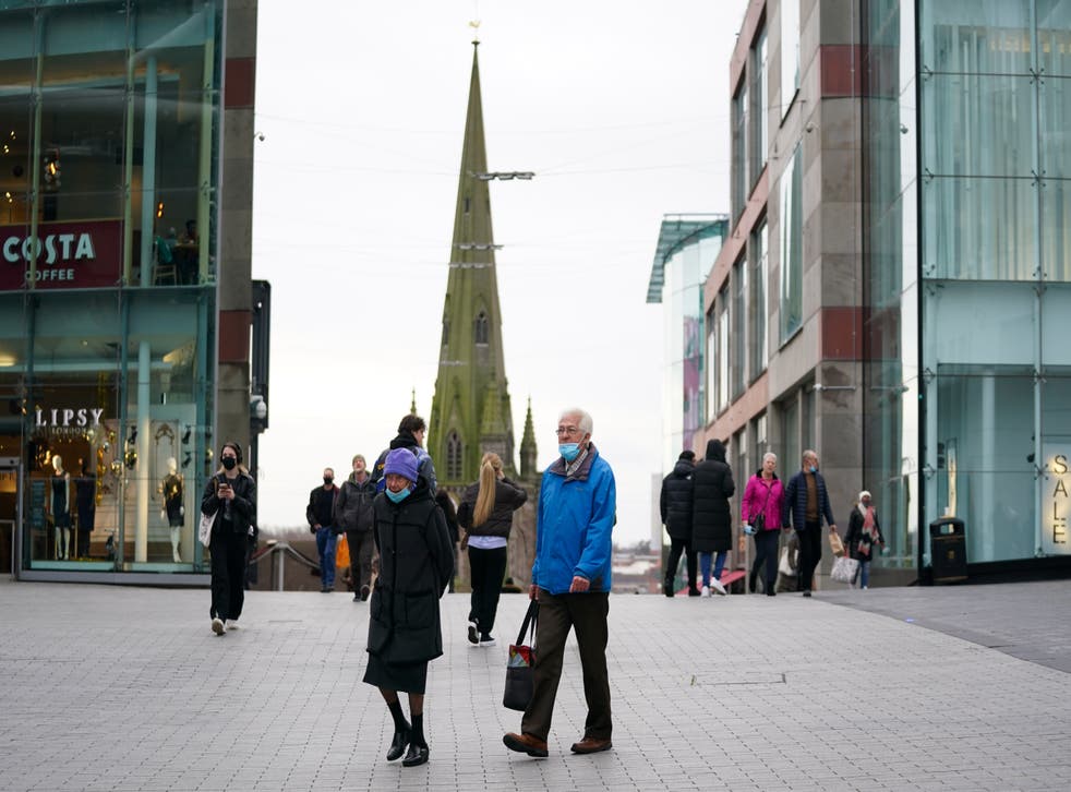 A couple wearing face masks by the Bullring shopping centre in Birmingham (Jacob King/PA)