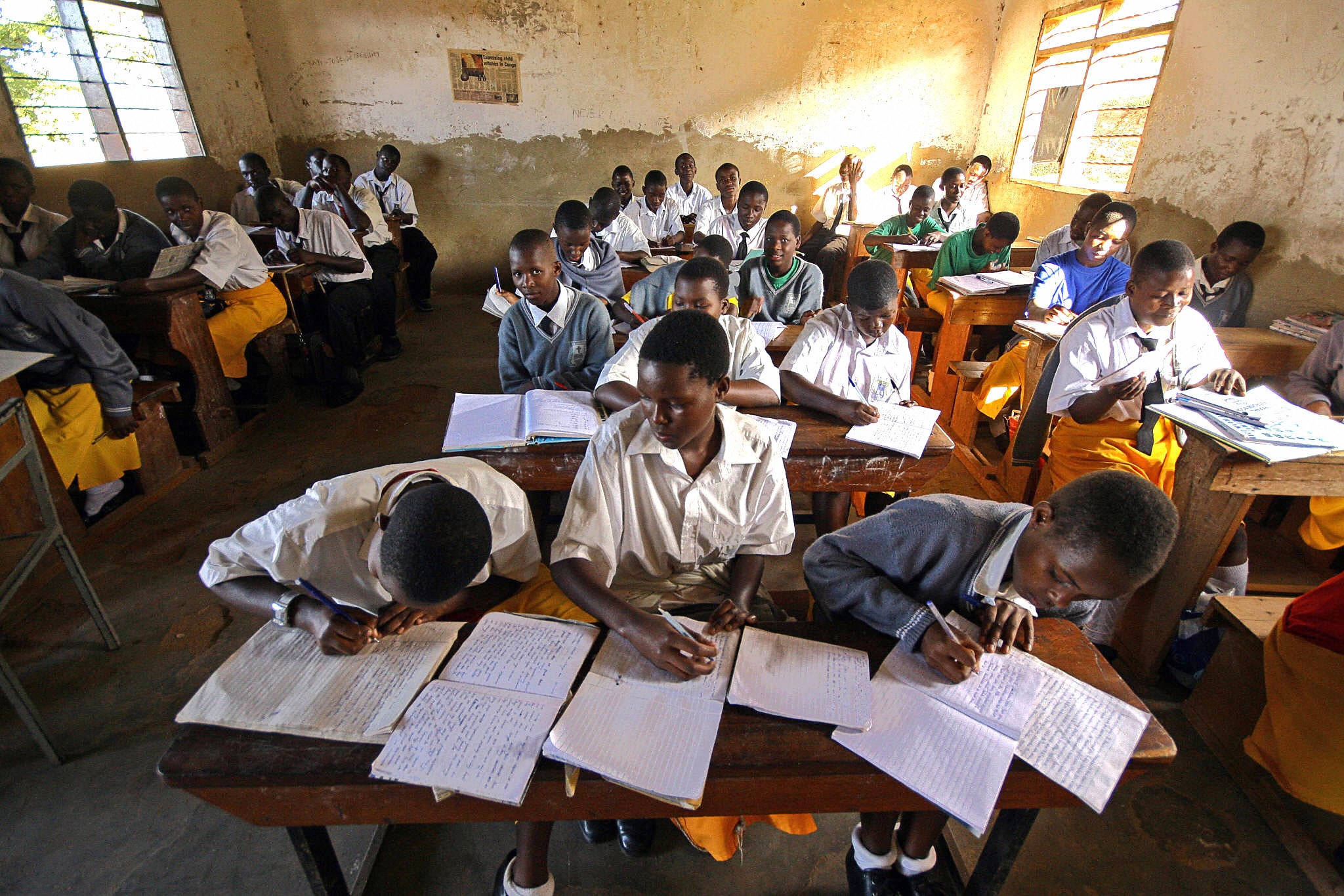 Pupils take notes at Saint Denis Ssebugwawo secondary school in Kampala, Uganda