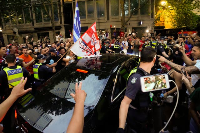 Fans clashed with police in Melbourne after Novak Djokovic won his appeal against deportation (Mark Baker/AP)