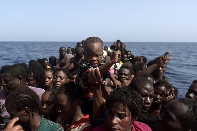 <p>Migrants waiting to be rescued off the Libyan coast </p>
