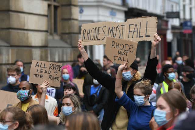 <p>Protesters in Oxford during a protest calling for the removal of the statue of Cecil Rhodes from Oriel college</p>