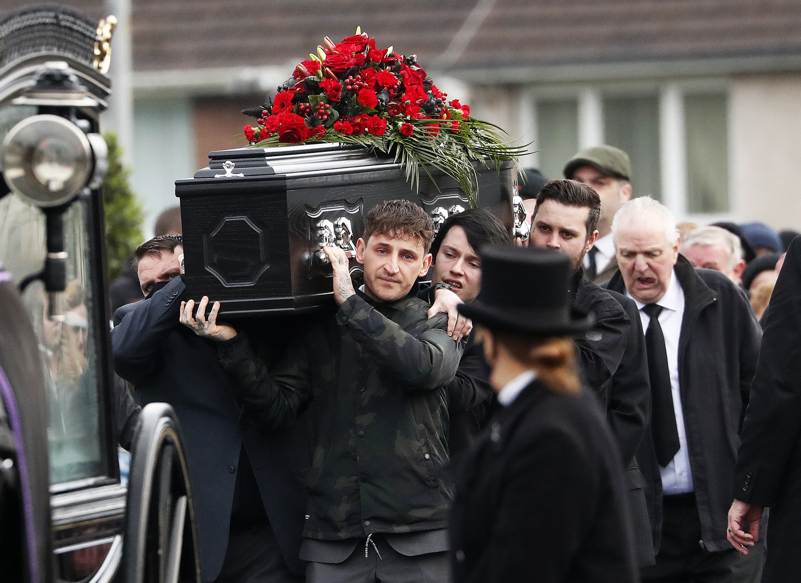 Family and friends carry the coffin of Aidan Mann from his funeral (Peter Morrison/PA)