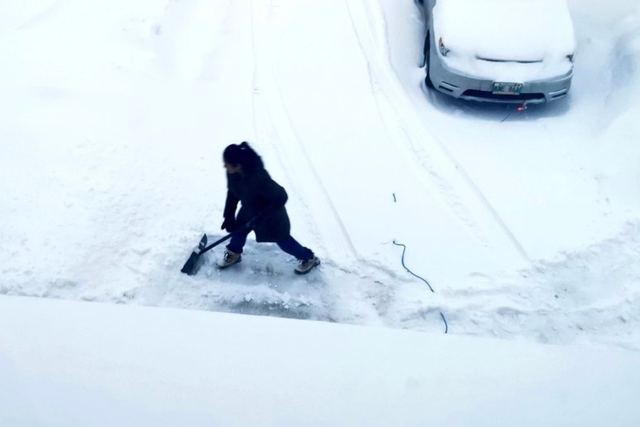 <p>Jon Reyes shared a photo of his wife shovelling snow in their driveway </p>