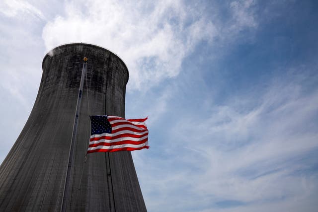 <p>The US flag in front of a coal-fired power plant’s cooling tower at Duke Energy’s Crystal River Energy Complex in  Florida. US emissions rebounded in 2021 largely due to an uptick in coal power use</p>