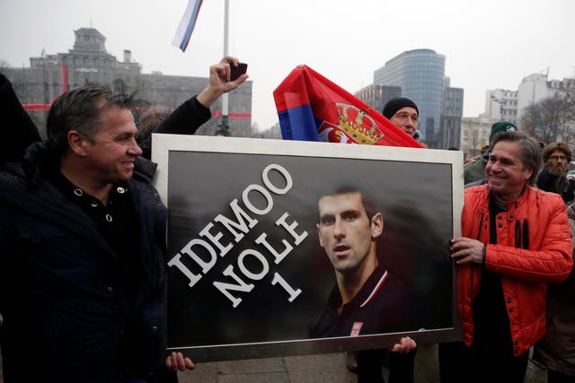 <p>Supporters of Serbian tennis player Novak Djokovic hold a banner during a protest in Belgrade, Serbia, 8 January 2022</p>