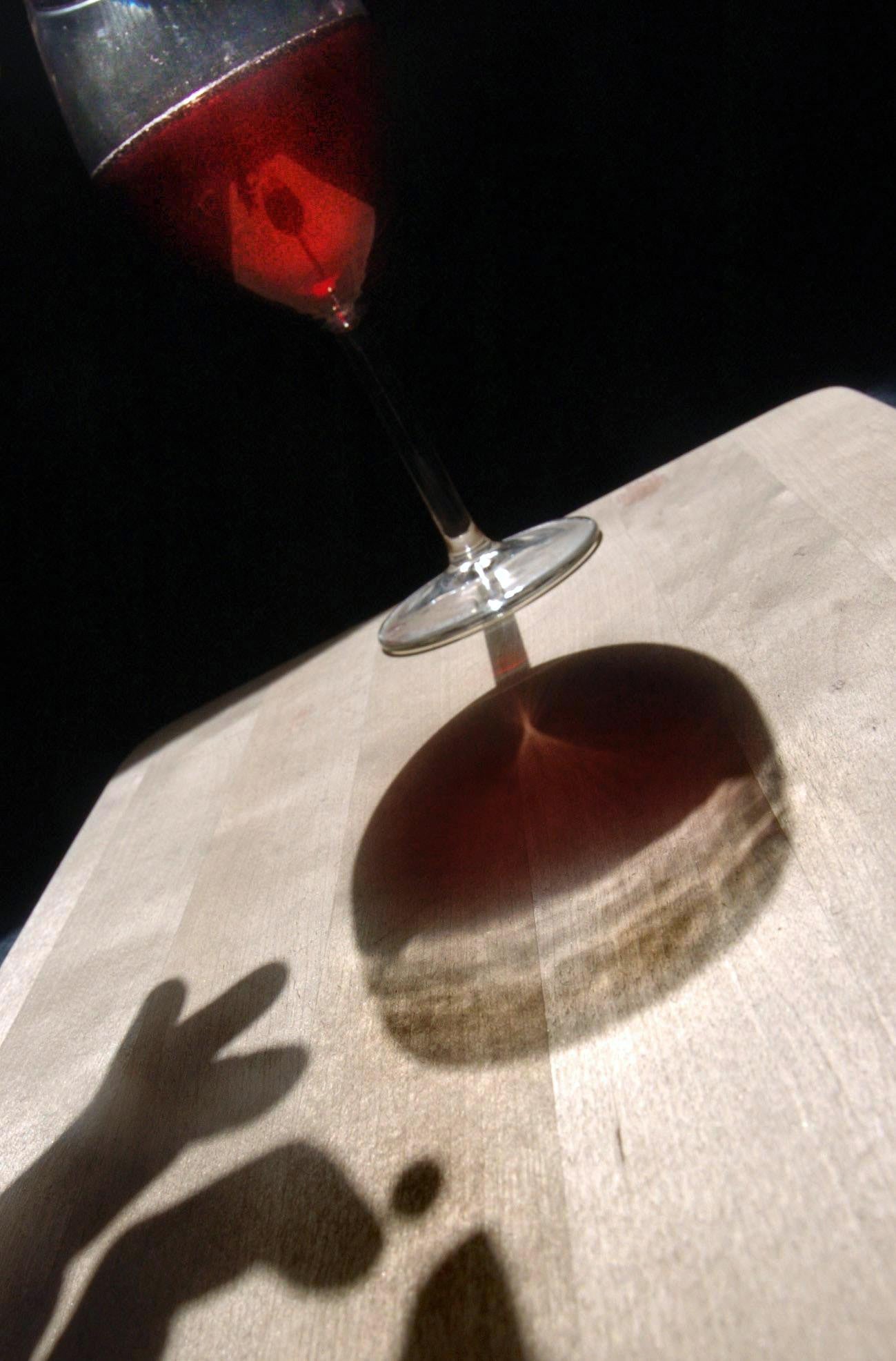 Posed photograph of an alcoholic drink (glass of wine) being spiked. (Danny Lawson/PA)