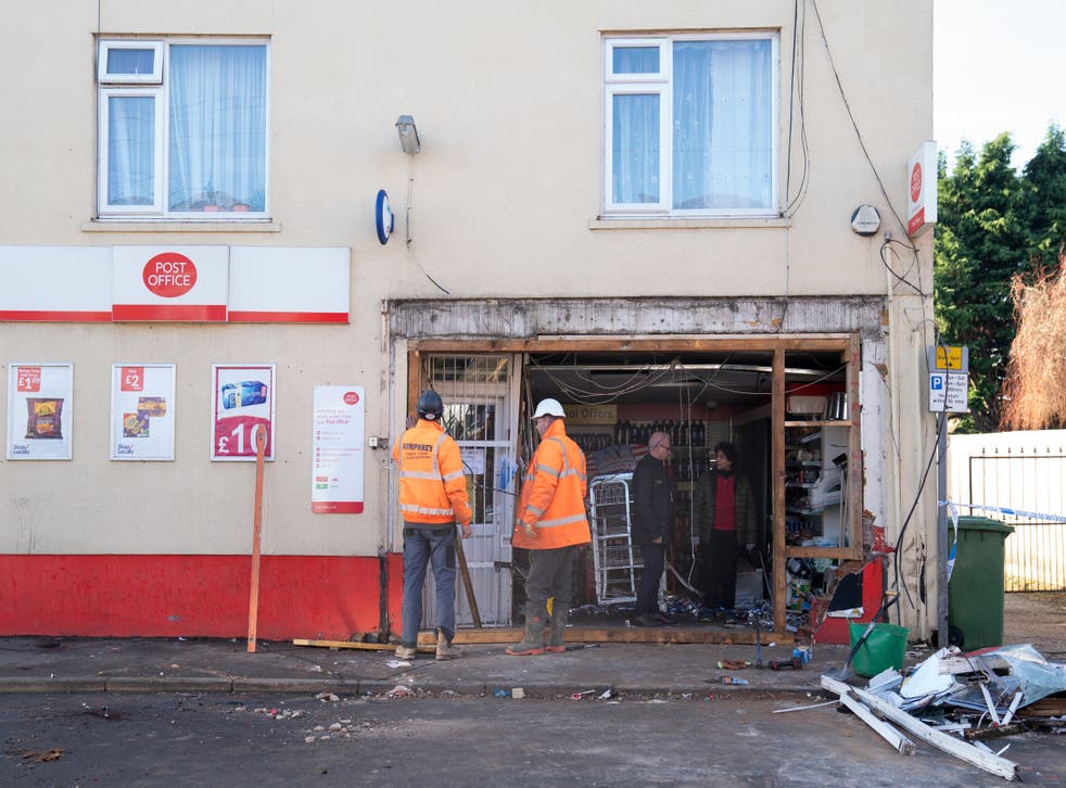 The scene at Old Walsoken Post Office in Wisbech, Cambridgeshire, after thieves broke in using a JCB low loader and made off with the cash machine in the early hours of the morning (Joe Giddens/ PA)